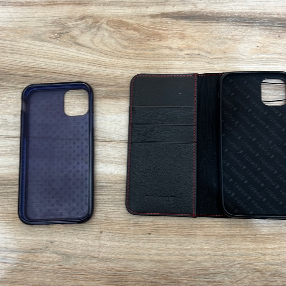 Three iPhone cases, the two dark ones for 11 and the pink for iPhone 13.